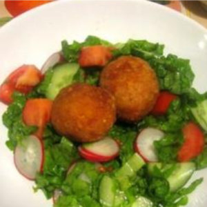 Breaded Eggs on a Salad with Garlic Sauce