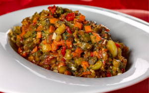Turkish-Style Eggplant – You Need 1 kg Eggplant, 500 g Tomatoes, 500 g Bell Peppers, 2 Medium Onions, 3 Garlic Cloves, Salt, and Oil
